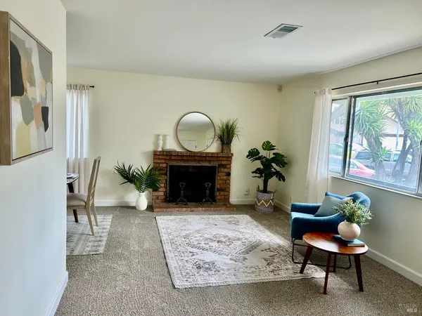 a view of a livingroom with furniture and a potted plant
