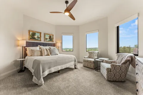 a spacious bedroom with bed and a couch