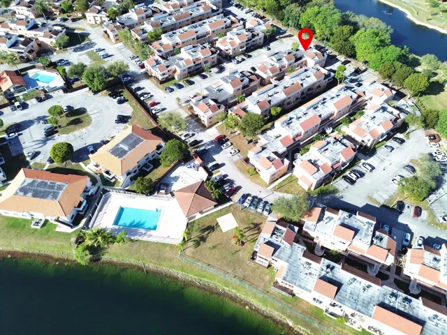 an aerial view of residential houses with yard