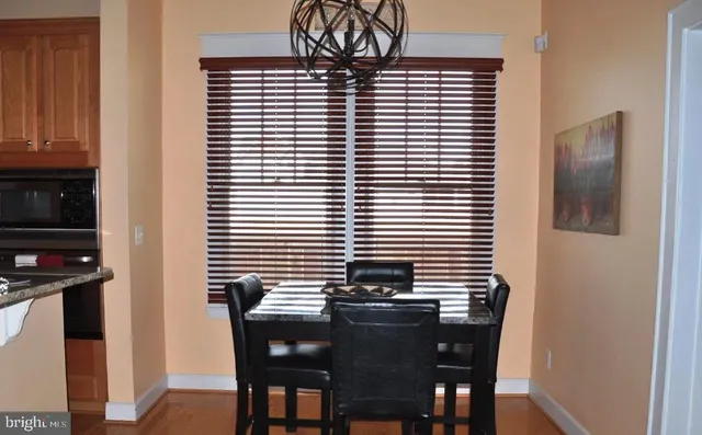 a view of a dining room with furniture and chandelier