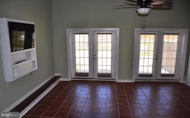 a view of empty room with a window and wooden floor