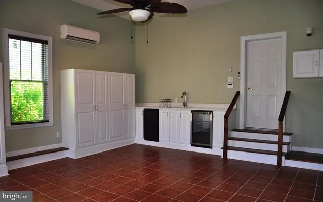 a view of a livingroom with furniture and staircase