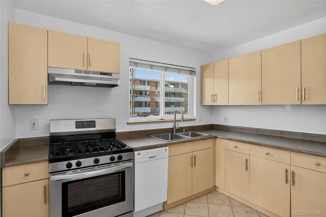 a kitchen with granite countertop white cabinets and appliances