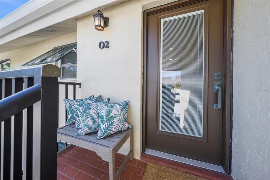 4660 Ocean Boulevard, Unit O2 Sarasota, FL 34242 - Photo 11 of 55 a view of entryway and hall with wooden floor