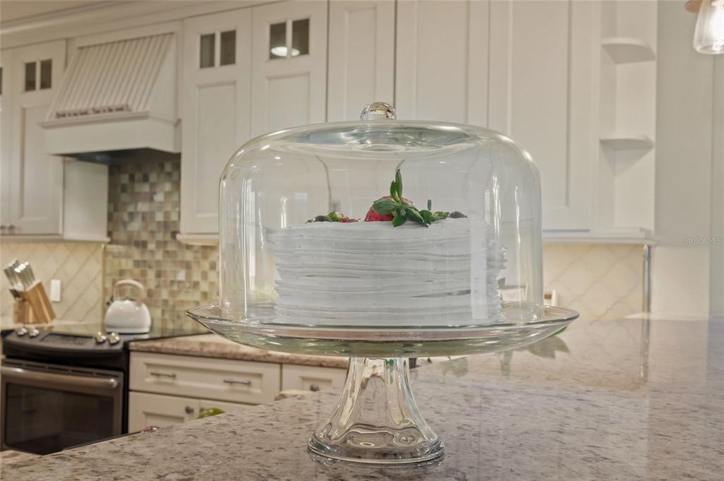 4660 Ocean Boulevard, Unit O2 Sarasota, FL 34242 - Photo 14 of 55 a kitchen with a sink and cabinets