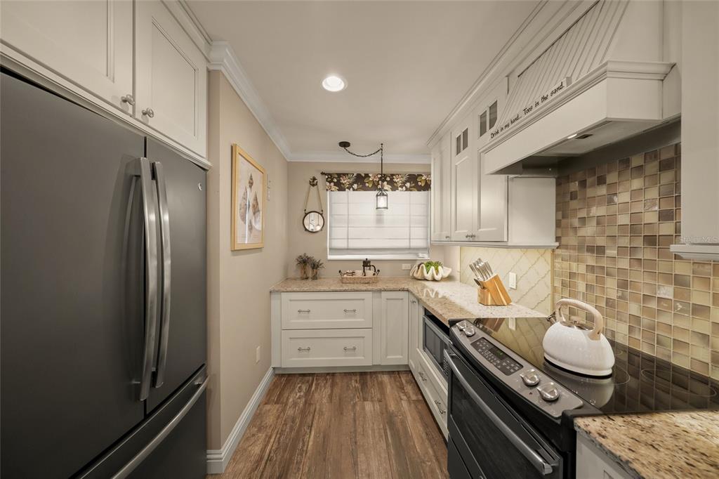 4660 Ocean Boulevard, Unit O2 Sarasota, FL 34242 - Photo 15 of 55 a kitchen with a sink stove and refrigerator