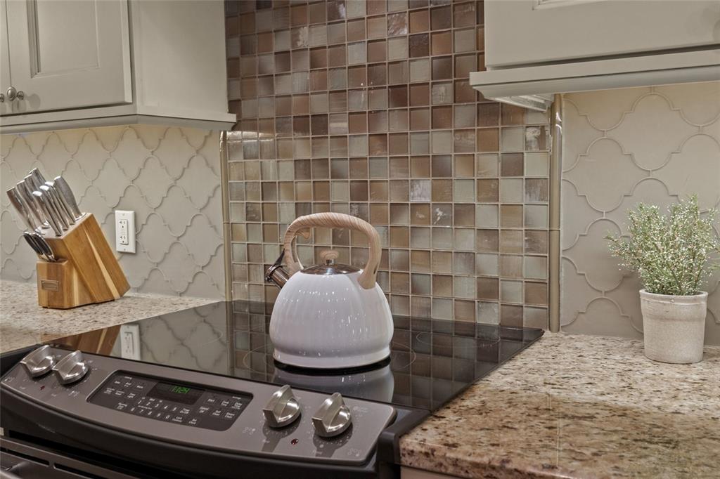 4660 Ocean Boulevard, Unit O2 Sarasota, FL 34242 - Photo 16 of 55 a table with a stove and a vase of white sitting next to a window