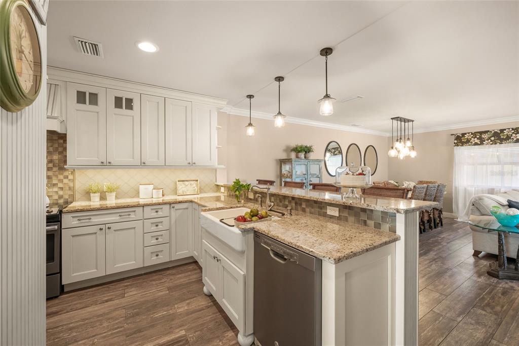 4660 Ocean Boulevard, Unit O2 Sarasota, FL 34242 - Photo 18 of 55 a kitchen with a sink stove and cabinets