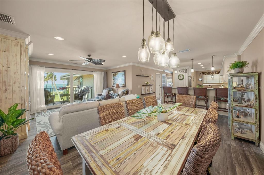 4660 Ocean Boulevard, Unit O2 Sarasota, FL 34242 - Photo 20 of 55 a living room with lots of furniture and a chandelier