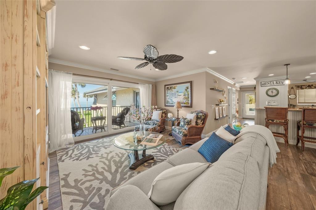 4660 Ocean Boulevard, Unit O2 Sarasota, FL 34242 - Photo 22 of 55 a living room with furniture and a large window