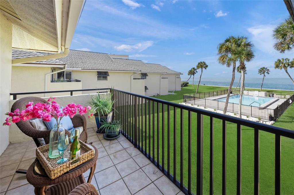 4660 Ocean Boulevard, Unit O2 Sarasota, FL 34242 - Photo 24 of 55 a view of a patio with a table and chairs