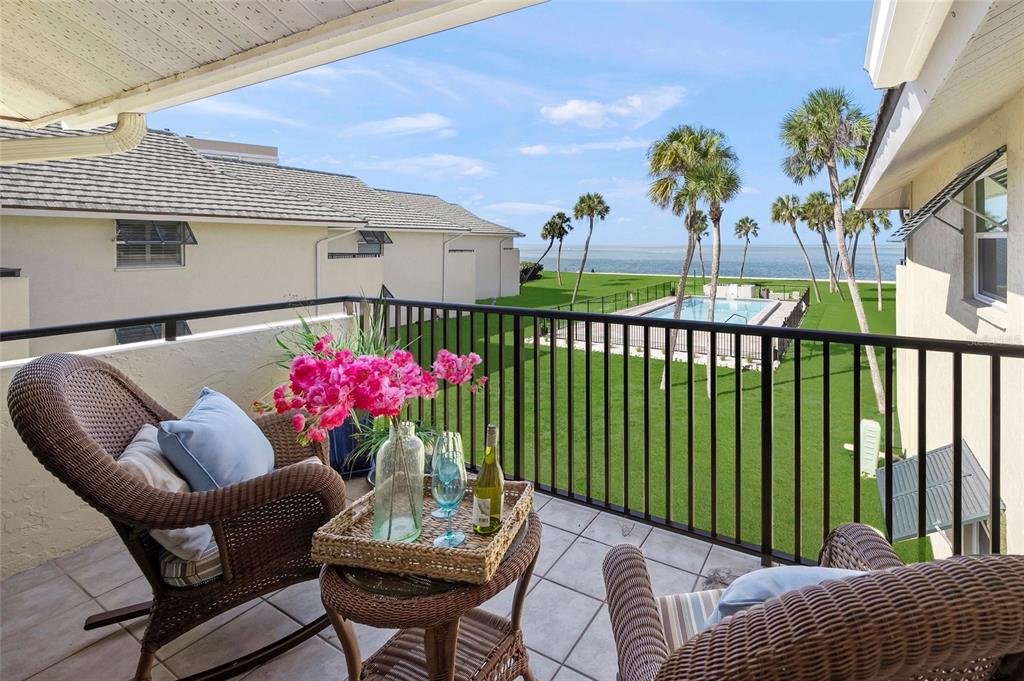 4660 Ocean Boulevard, Unit O2 Sarasota, FL 34242 - Photo 25 of 55 a view of a patio with a table and chairs