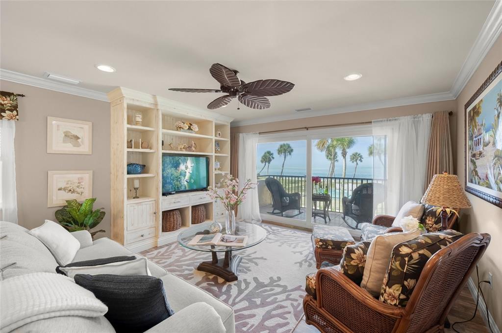 4660 Ocean Boulevard, Unit O2 Sarasota, FL 34242 - Photo 3 of 55 a living room with furniture a flat screen tv and a large window