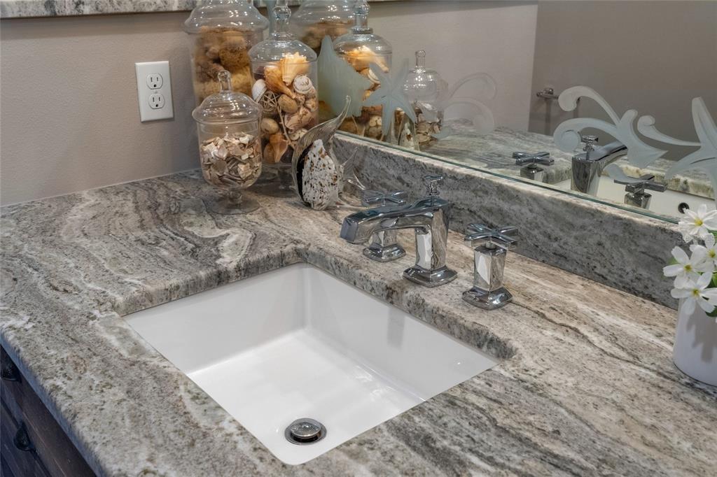 4660 Ocean Boulevard, Unit O2 Sarasota, FL 34242 - Photo 34 of 55 a bathroom with a granite countertop sink and a mirror