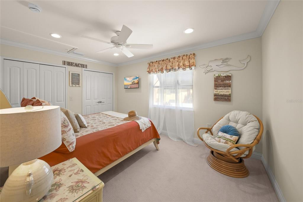 4660 Ocean Boulevard, Unit O2 Sarasota, FL 34242 - Photo 39 of 55 a bedroom with a bed and a window