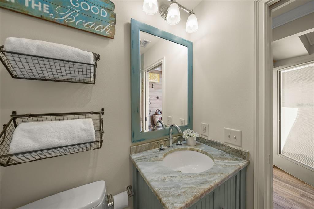 4660 Ocean Boulevard, Unit O2 Sarasota, FL 34242 - Photo 42 of 55 a bathroom with a granite countertop sink and a mirror