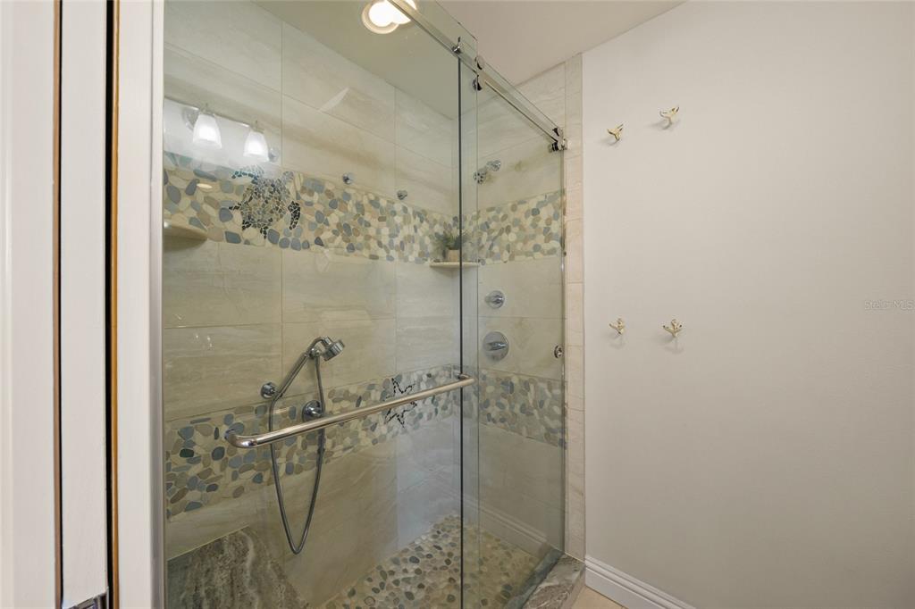 4660 Ocean Boulevard, Unit O2 Sarasota, FL 34242 - Photo 43 of 55 a bathroom with a shower