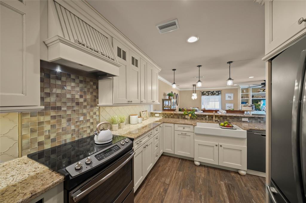 4660 Ocean Boulevard, Unit O2 Sarasota, FL 34242 - Photo 6 of 55 a kitchen with stainless steel appliances granite countertop a stove and a sink