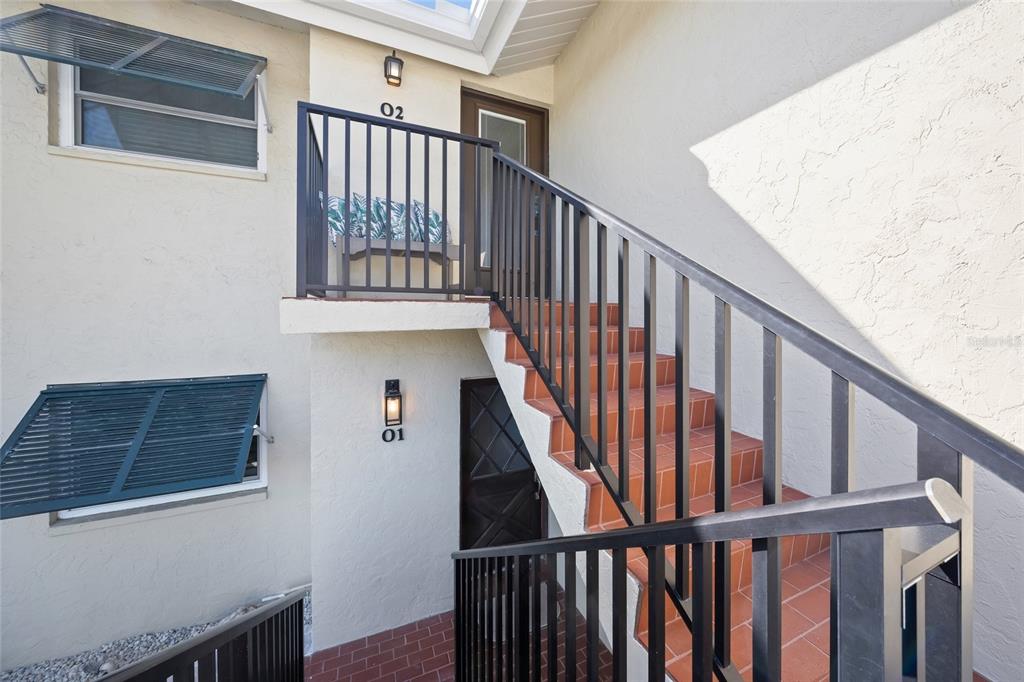 4660 Ocean Boulevard, Unit O2 Sarasota, FL 34242 - Photo 10 of 55 a view of staircase with railing and white walls