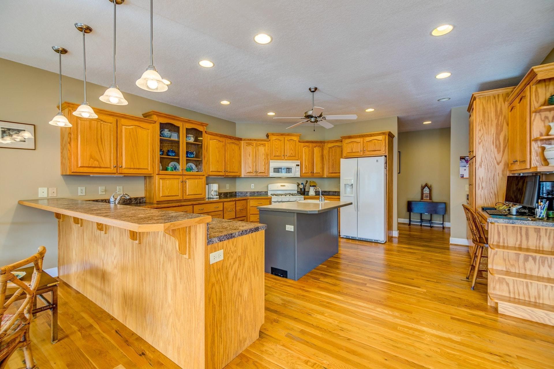 2774 Republican Church Road Ferrum, VA 24088 - Photo 28 of 52 a large kitchen with kitchen island a large counter top space a sink stainless steel appliances and cabinets