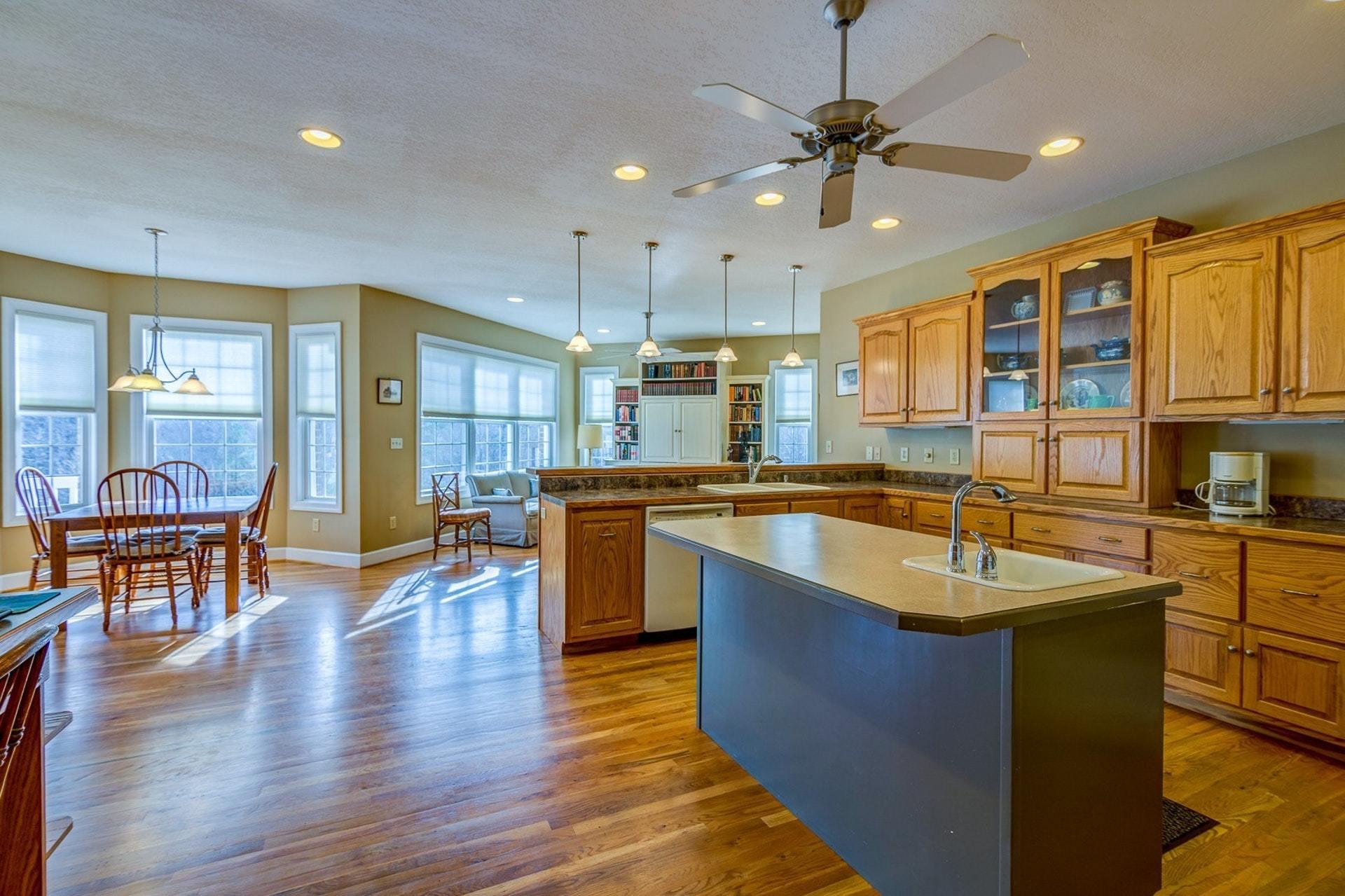 2774 Republican Church Road Ferrum, VA 24088 - Photo 5 of 52 a large kitchen with stainless steel appliances granite countertop a refrigerator a sink dishwasher a dining table and chairs with wooden floor