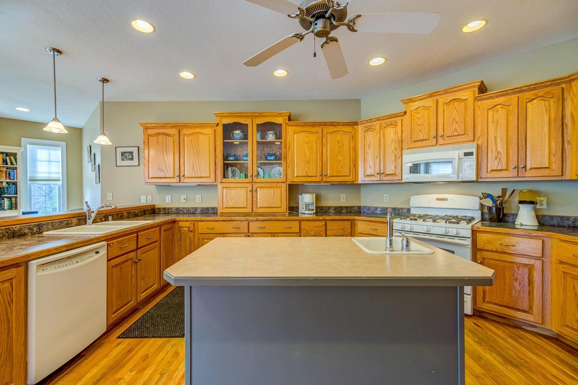 2774 Republican Church Road Ferrum, VA 24088 - Photo 6 of 52 a kitchen with a sink a stove a refrigerator and cabinets