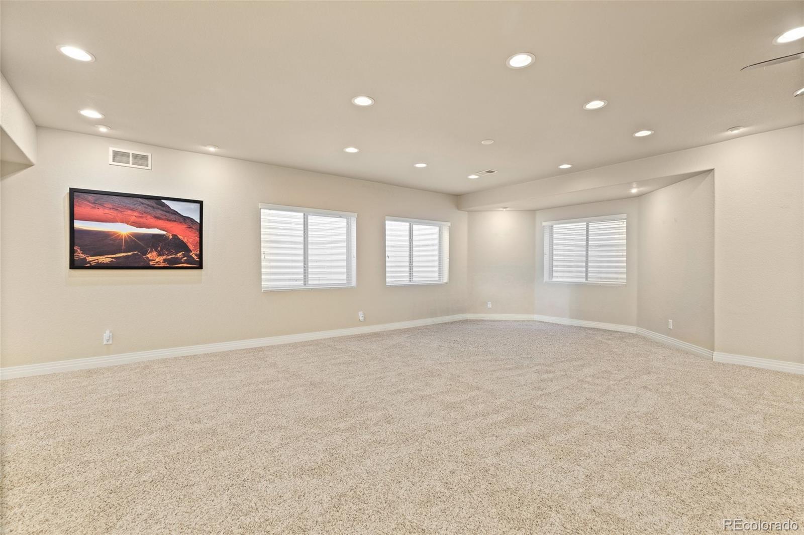 41865 East Muirfield Loop Elizabeth, CO 80107 - Photo 29 of 50 an empty room with windows and ceiling fan