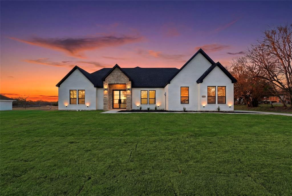 1125 East Malloy Bridge Road Seagoville, TX 75159 - Photo 1 of 1 Back of property at dusk featuring stone siding and a yard