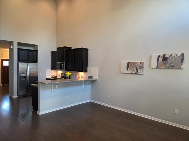 a kitchen with refrigerator and cabinets