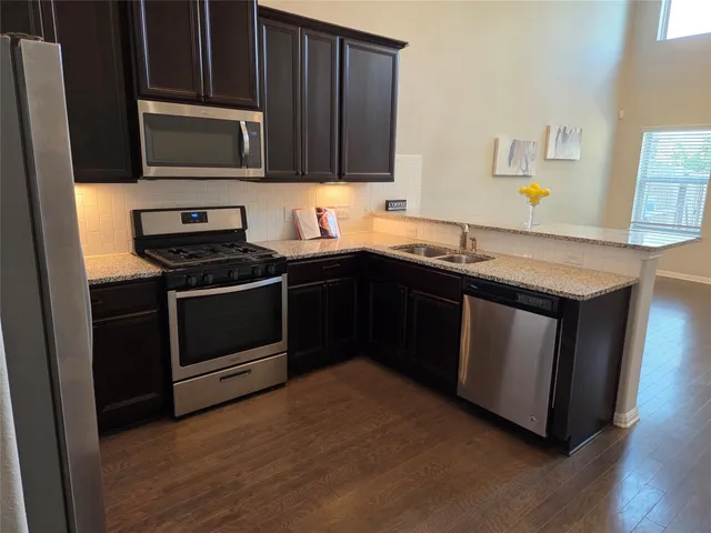 a kitchen with a sink stove and microwave
