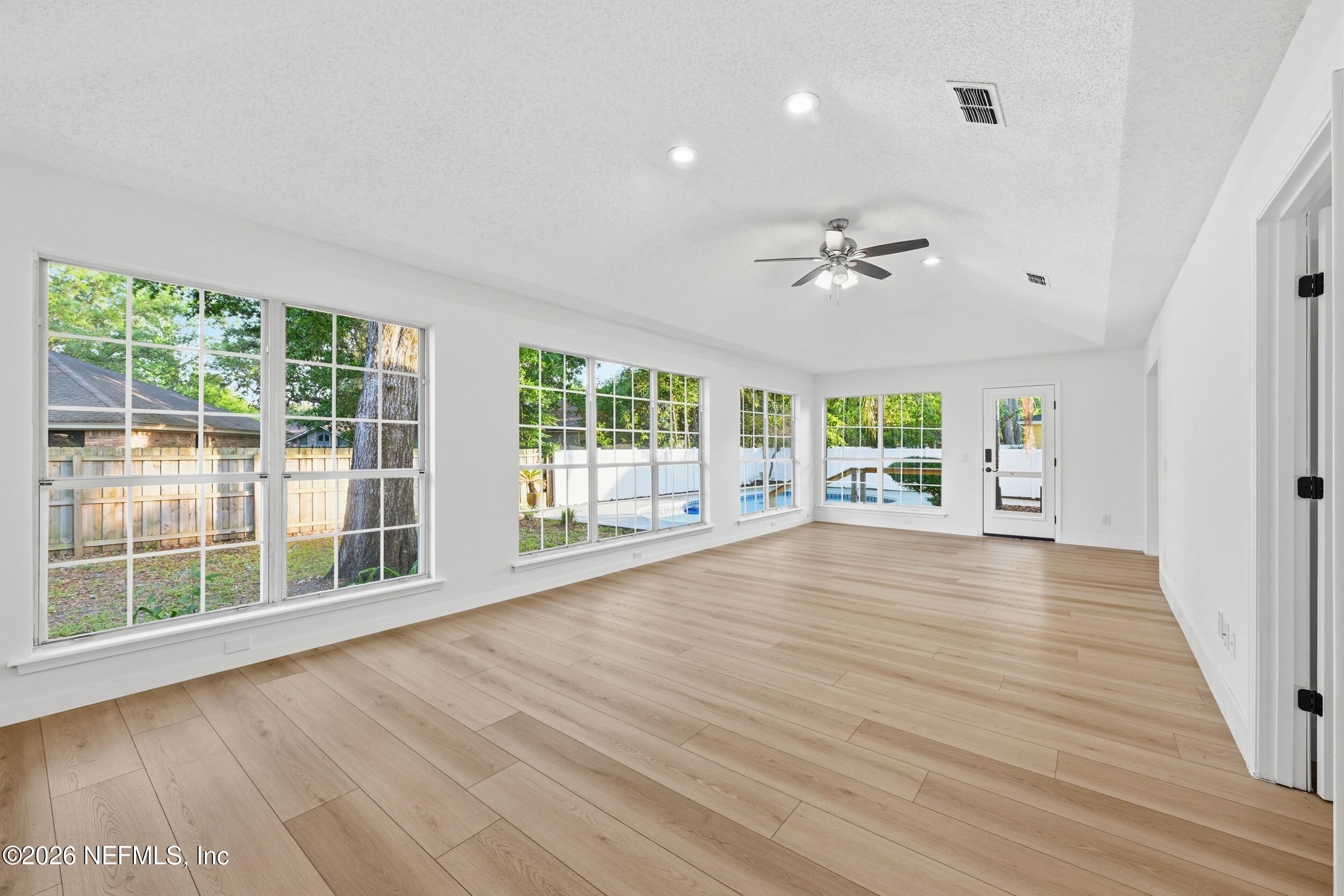 3286 Marbon Road Jacksonville, FL 32223 - Photo 30 of 36 a view of an empty room with wooden floor and a window