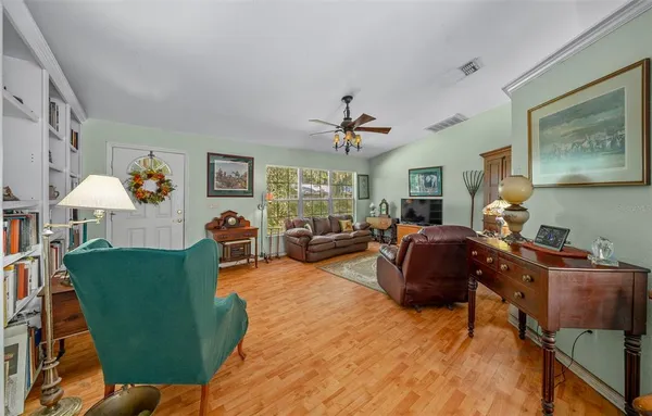 a living room with furniture and a book shelf