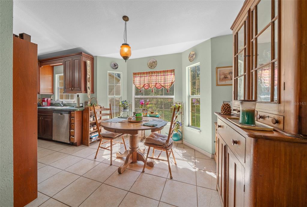 399 Northeast 155 Place Citra, FL 32113 - Photo 25 of 58 a large kitchen with a table and chairs