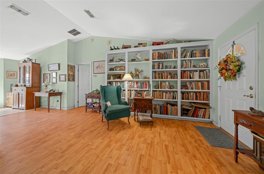 399 Northeast 155 Place Citra, FL 32113 - Photo 27 of 58 a living room with furniture and a book shelf