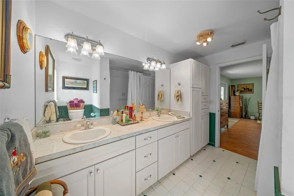 a kitchen with granite countertop a sink window and cabinets