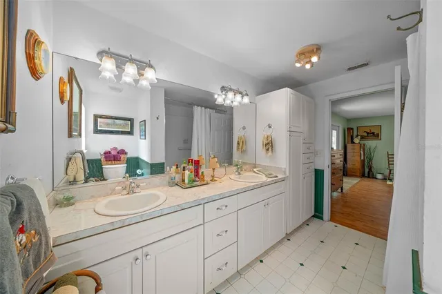 a kitchen with granite countertop a sink window and cabinets