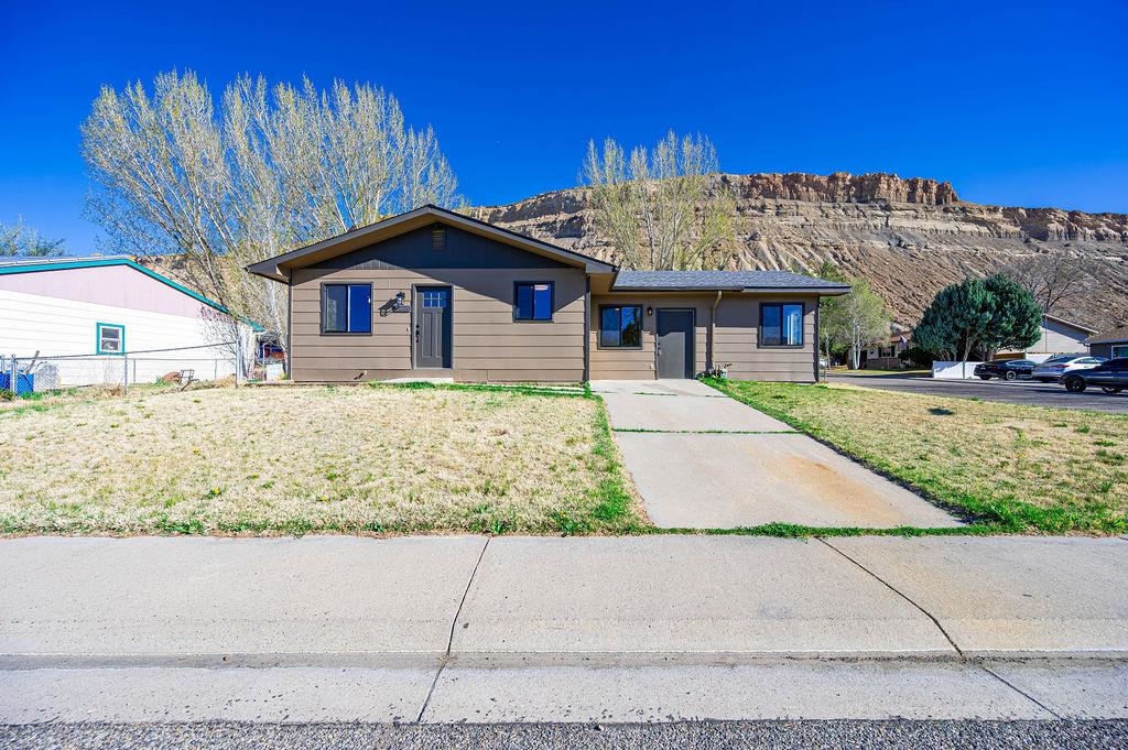 508 Rosa Street Palisade, CO 81526 - Photo 1 of 18 a front view of a house with a yard