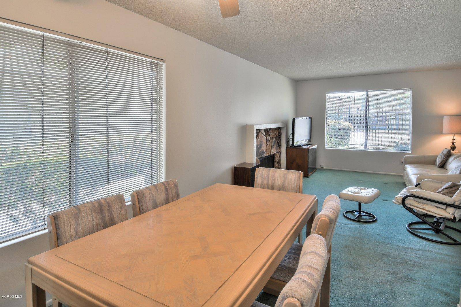 547 Spring Road, Unit 33 Moorpark, CA 93021 - Photo 11 of 28 a bedroom with a bed and a couch next to a window