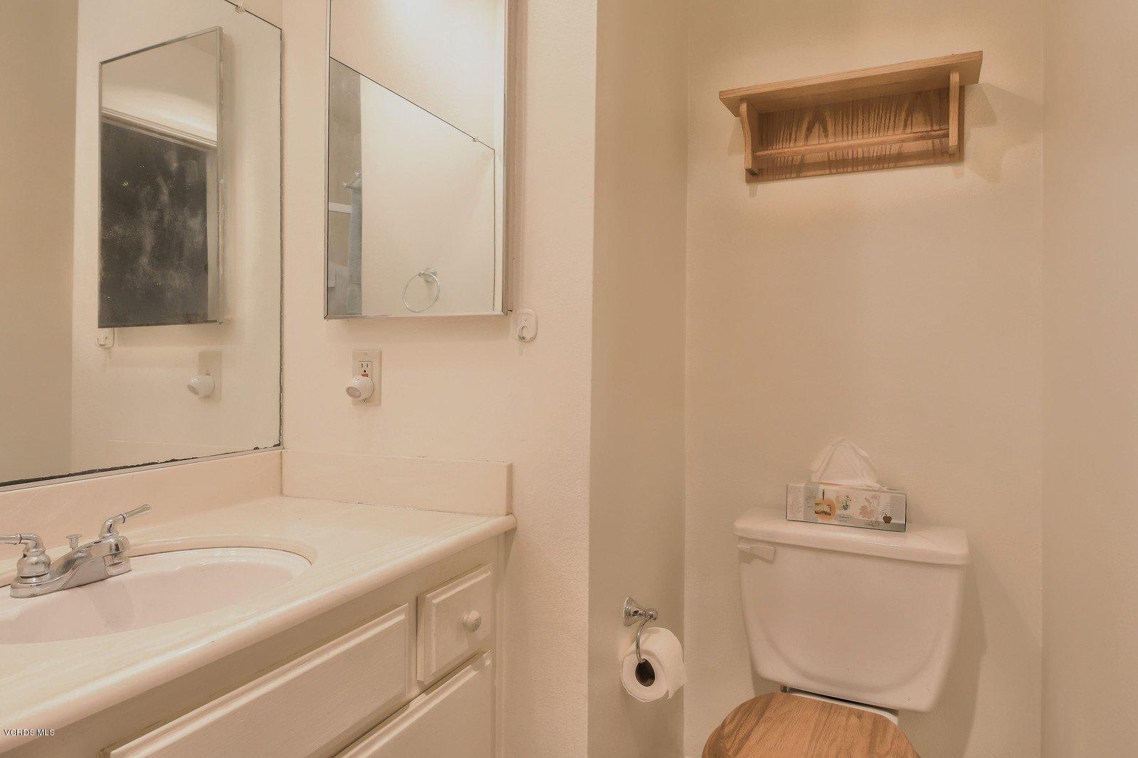 547 Spring Road, Unit 33 Moorpark, CA 93021 - Photo 19 of 28 a bathroom with a granite countertop sink and a mirror