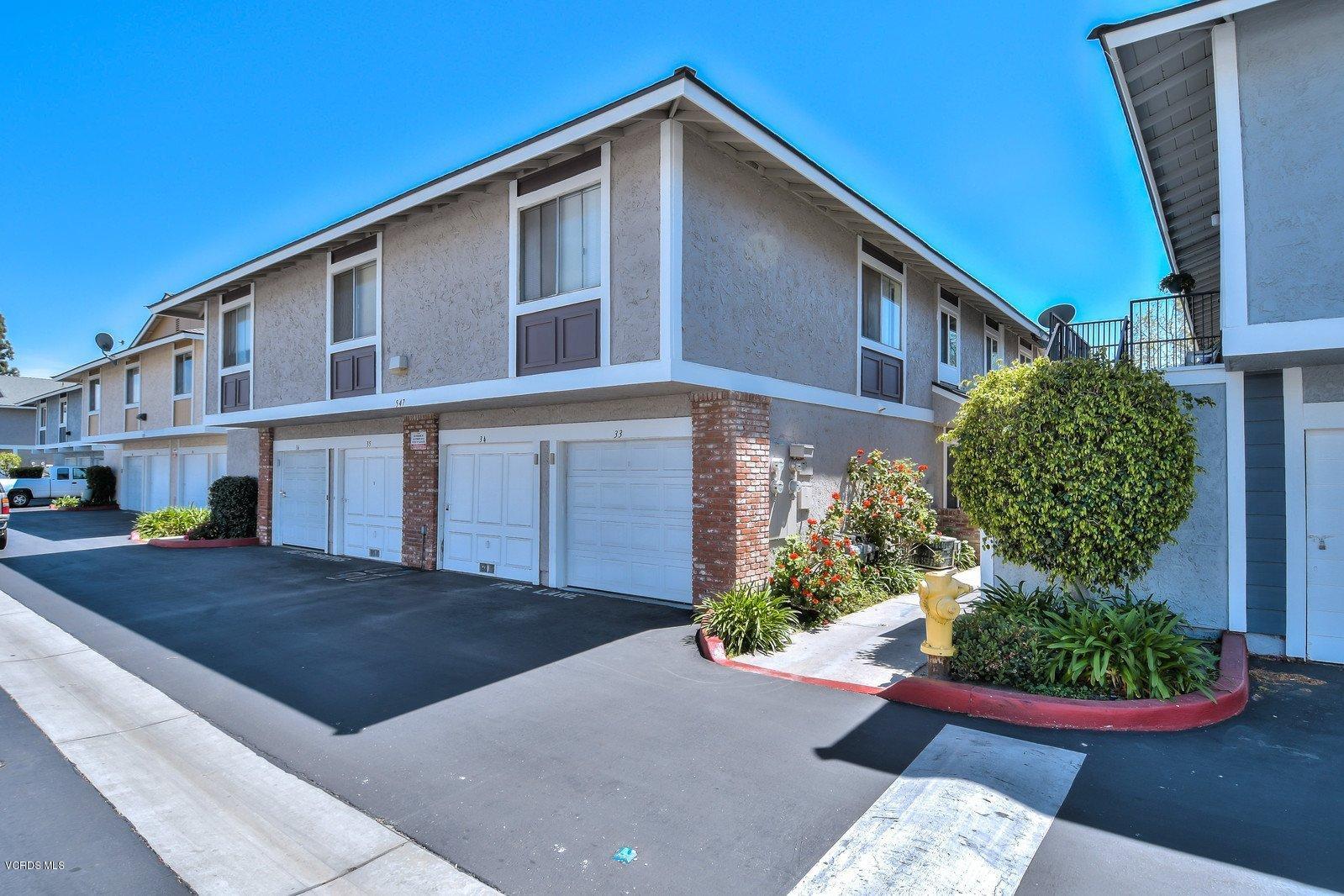 547 Spring Road, Unit 33 Moorpark, CA 93021 - Photo 24 of 28 a front view of a house with a yard