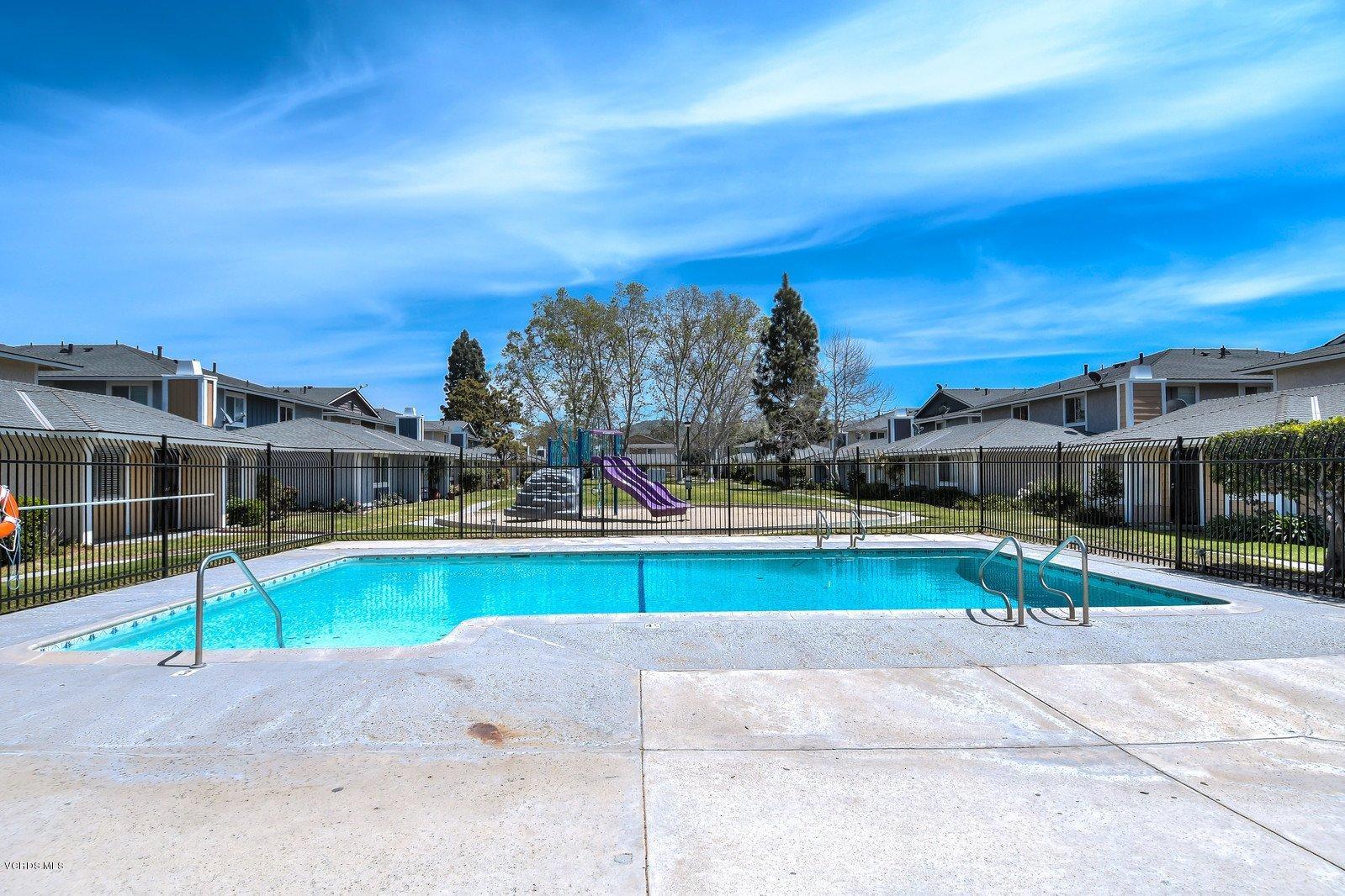 547 Spring Road, Unit 33 Moorpark, CA 93021 - Photo 26 of 28 a view of a swimming pool with a lawn chairs under an umbrella