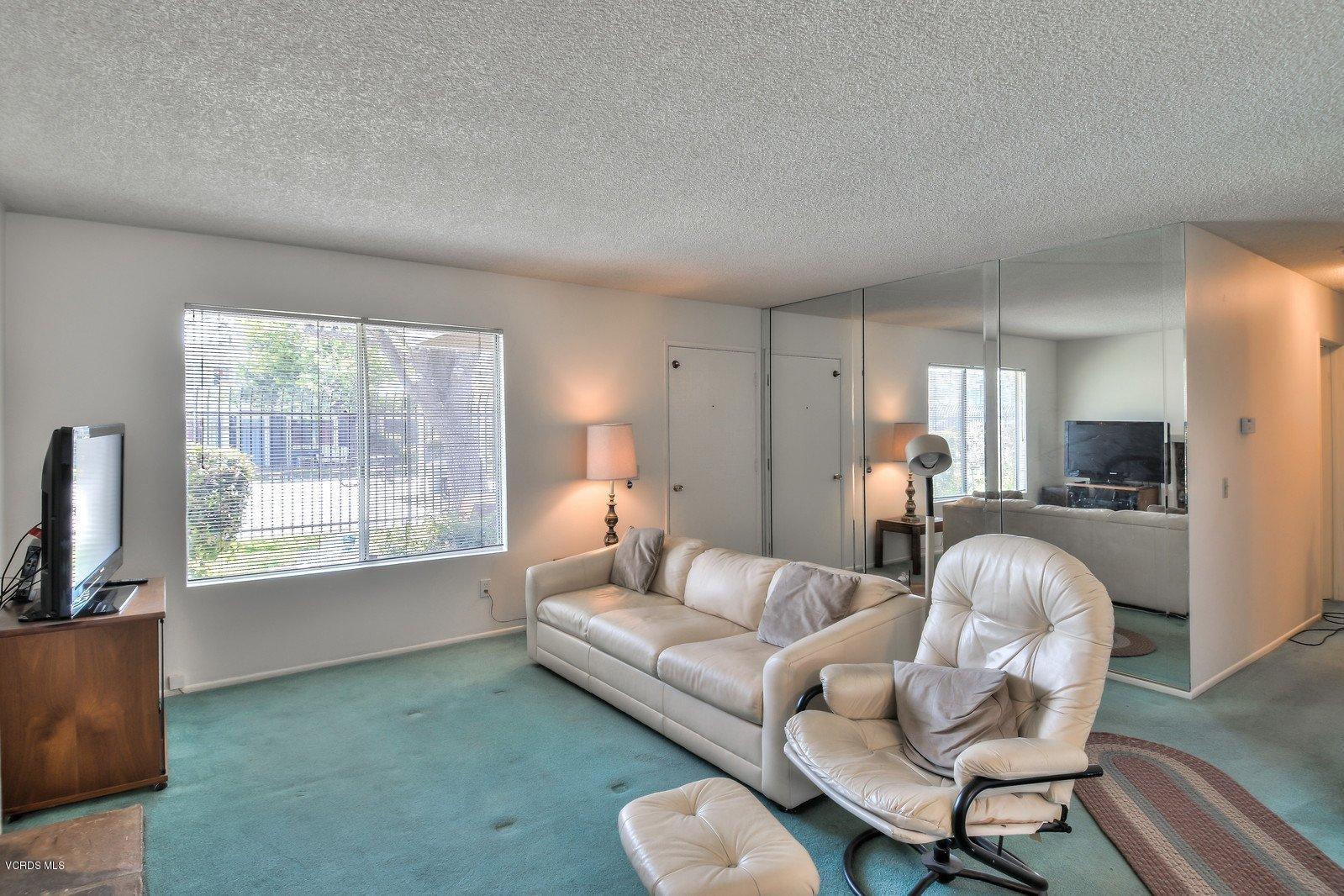 547 Spring Road, Unit 33 Moorpark, CA 93021 - Photo 6 of 28 a living room with furniture a fireplace and a large window