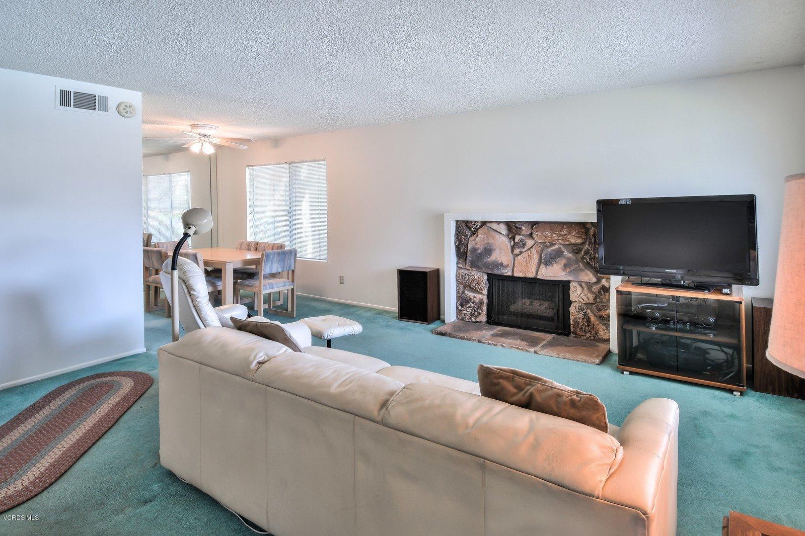 547 Spring Road, Unit 33 Moorpark, CA 93021 - Photo 10 of 28 a living room with furniture and a flat screen tv