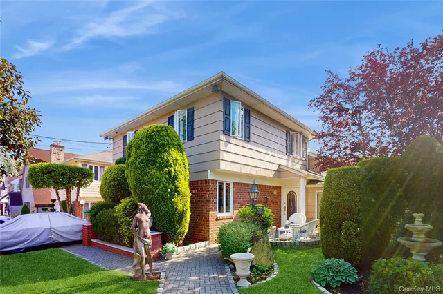 a front view of a house with garden