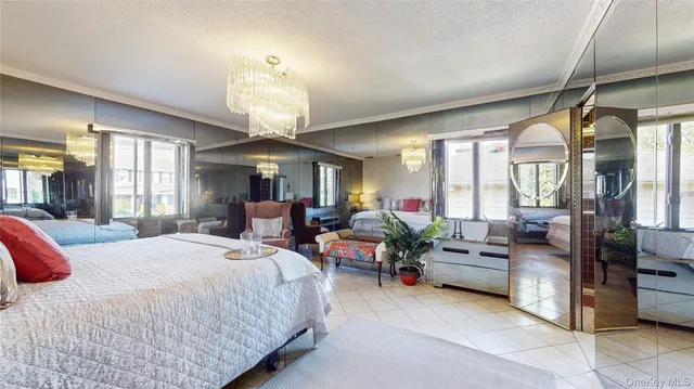 a bedroom with a large bed and ceiling fan