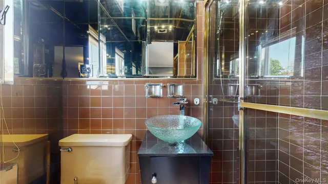 a bathroom with a sink mirror toilet and shower