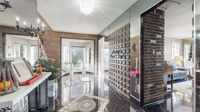 a view of an entryway with wooden floor and chandelier