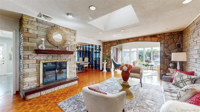 a living room with furniture a fireplace and a large window