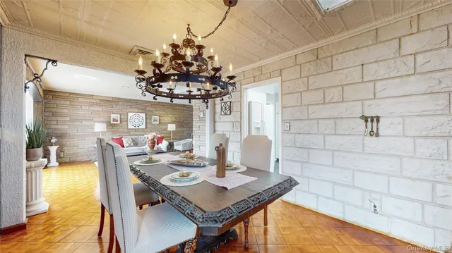 a view of a dining room with furniture and a chandelier fan