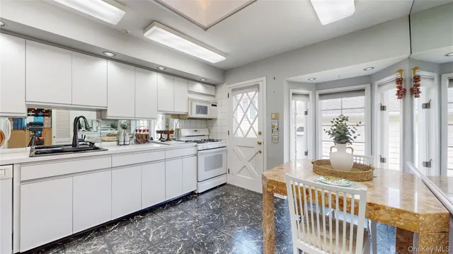 a kitchen with sink a refrigerator and cabinets